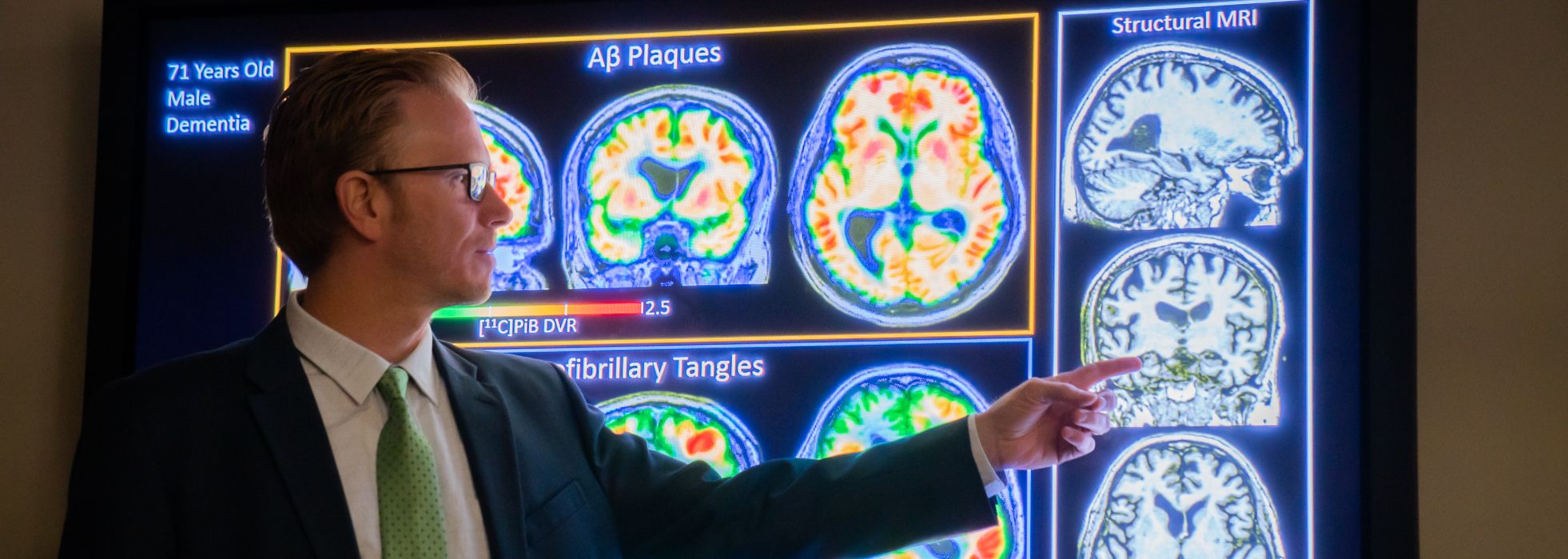 Dr. Sterling Johnson showing images of brain scans.