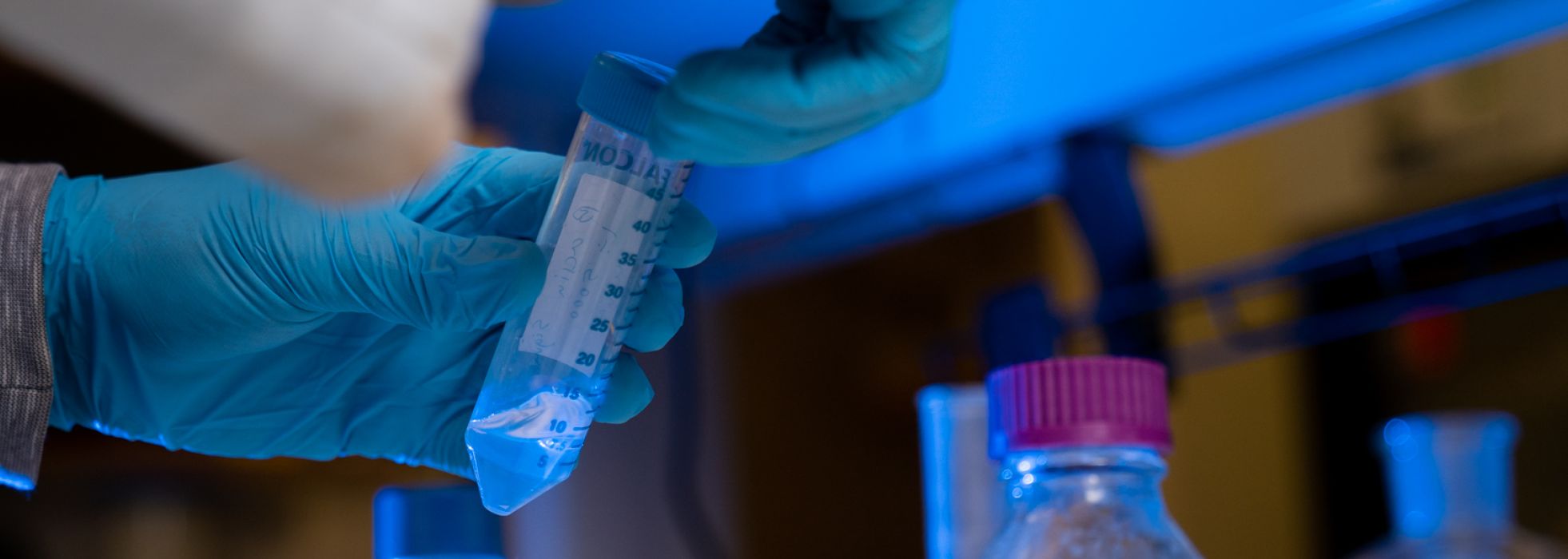 Closeup photo of researcher holding test tube in the lab