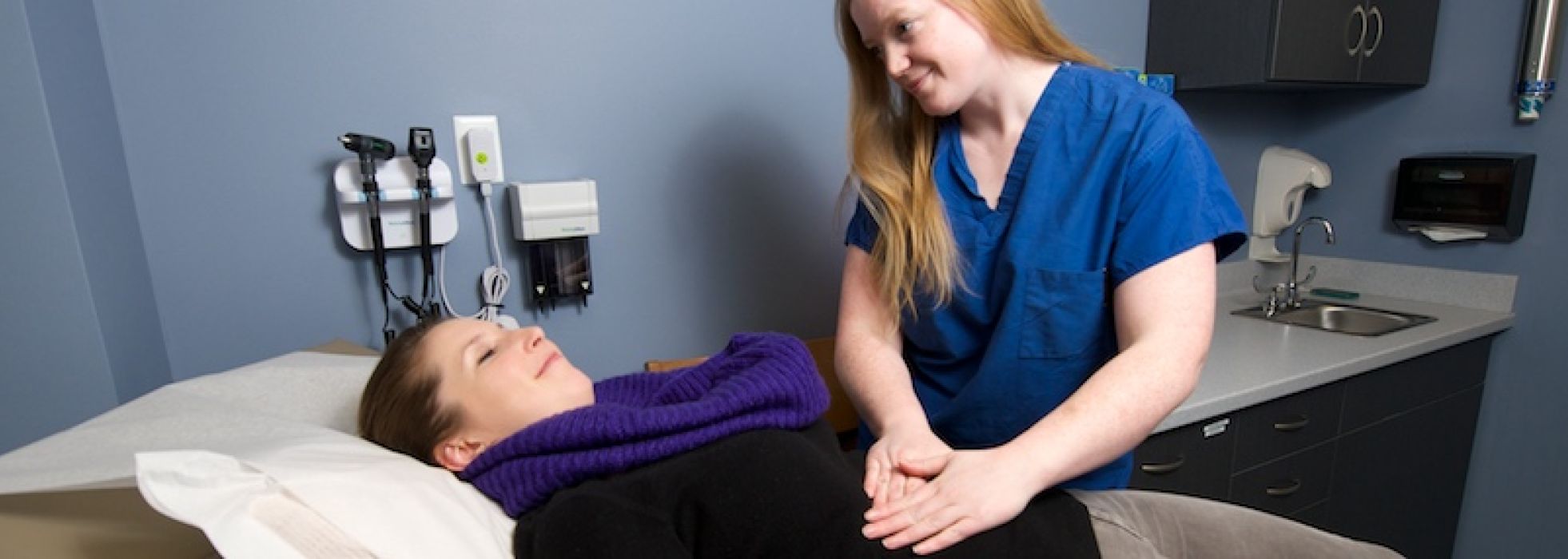 Dr. Siobhan Byrne examines a patient on a table in the GI clinic
