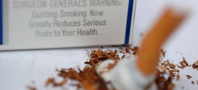 Photo of surgeon general's warning and putting out cigarette