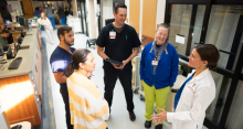 Dr. Kruser, far right, in communication with interdisciplinary ICU team members, which include (from right) Sherry McMullan, BSN, RN; Matt Willenborg, PharmD, BCPS; Wesley Hoppe, BSN, RN; and &nbsp;Olivia Orencia, MSW, APSW. Credit: Clint Thayer/Department of Medicine.