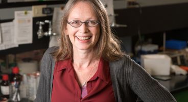 Dr. Rozalyn Anderson smiling in her lab.