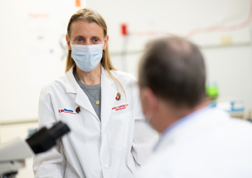 Cindy Zuleger, PhD, talks with Dr. Mark Albertini in his lab