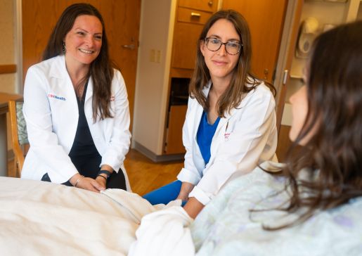 Doctors Anna Heimbecher, and Maggie Steingraber-Pharr consult at bedside