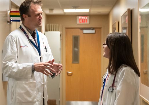 John Rice in hallway with colleague