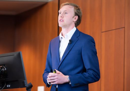 A medical student presenting at a DOM research event