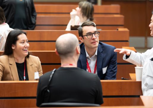 DOM faculty and learners chatting before the Education Day Grand Rounds.