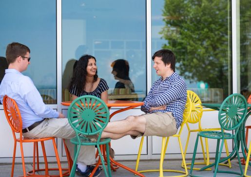 Graduating residents sitting around a table outside