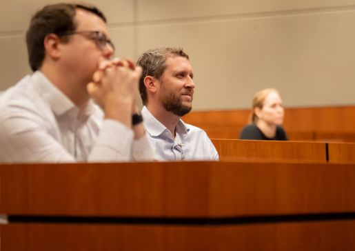 Several people in seats of a lecture hall